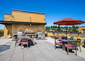 Thumbnail 17 of 39 - Lux Apartments Rooftop Patio with Grills