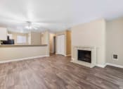 Thumbnail 11 of 20 - Saratoga Apartments in Everett, Washington Living Room with Fireplace and Kitchen