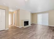 Thumbnail 9 of 20 - Saratoga Apartments in Everett, Washington Living Room with Fireplace and Private Patio