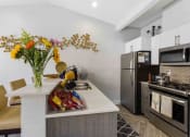 Thumbnail 5 of 20 - Saratoga Apartments in Everett, Washington Clubhouse Kitchen with Coffee Bar