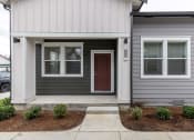 Thumbnail 14 of 30 - the front of a home with a brown door and a sidewalk