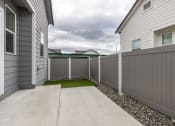 Thumbnail 13 of 30 - the yard of a home with a white fence and grass