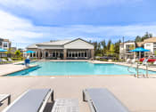 Thumbnail 28 of 30 - the preserve at ballantyne commons pool and building with chairs and umbrellas
