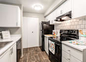 Thumbnail 11 of 16 - The Stinson Apartment Homes Model Kitchen