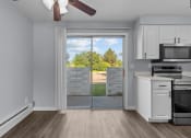 Thumbnail 5 of 34 - an empty kitchen with a door to a patio with a view