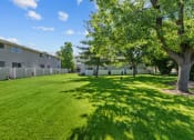 Thumbnail 31 of 34 - the backyard of a building with grass and trees