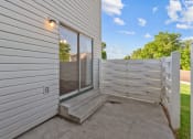 Thumbnail 22 of 34 - the backdoor of a house with a white fence and a glass door