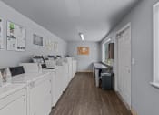 Thumbnail 24 of 34 - a laundry room with washes and dryers and a window
