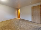 Thumbnail 18 of 25 - A spacious carpeted bedroom at Heron Hills apartments in Gresham Oregon.