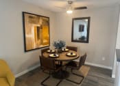 Thumbnail 8 of 26 - a dining room with a table and chairs