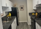 Thumbnail 9 of 26 - a kitchen with white cabinets and stainless steel appliances