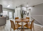 Thumbnail 3 of 24 - A dining room with a round table and chairs.