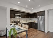 Thumbnail 28 of 28 - Apartments in Hollywood for Rent - The Fifty Five Fifty - A Spacious Open Kitchen With Stainless Steel Appliances, Dark Wood Cabinetry, And Wood-Style Flooring
