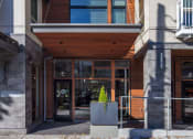 Thumbnail 28 of 36 - a building with a glass front door and a wood facade at The Hayes on Stone Way, Seattle, WA