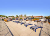 Thumbnail 12 of 36 - a row of lounge chairs on a roof top patio at The Hayes on Stone Way, Seattle, Washington