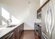 Thumbnail 19 of 36 - a kitchen with stainless steel appliances and a sink at The Hayes on Stone Way, Seattle, WA