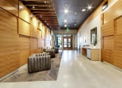 Thumbnail 23 of 36 - The Hayes on Stone Way Apartments large lobby with wood paneling and seating and a counter at The Hayes on Stone Way, Seattle, WA, 98103