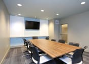 Thumbnail 26 of 36 - a conference room with a large wooden table and chairs at The Hayes on Stone Way, Seattle, WA, 98103