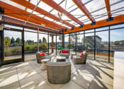 Thumbnail 2 of 36 - The Hayes on Stone Way Apartments patio with wicker chairs and a glass roof at The Hayes on Stone Way, Seattle, WA, 98103