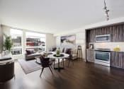 Thumbnail 5 of 36 - a living room with a kitchen and a table and chairs at The Hayes on Stone Way, Washington, 98103