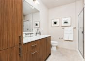 Thumbnail 8 of 36 - a bathroom with a toilet and a vanity with a large mirror at The Hayes on Stone Way, Seattle, WA, 98103