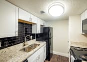 Thumbnail 4 of 18 - The Monet Apartments in Dallas, Texas Model Kitchen