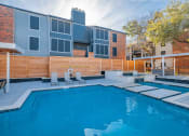 Thumbnail 14 of 18 - The Monet Apartments in Dallas, Texas Pool with Lounge Chairs