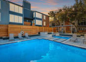 Thumbnail 13 of 18 - The Monet Apartments in Dallas, Texas Pool with Lounge Chairs