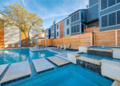 Thumbnail 15 of 18 - The Monet Apartments in Dallas, Texas Pool with Lounge Chairs