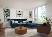 Thumbnail 25 of 30 - The Wes Gresham Oregon Apartments A living room with a blue couch and a brown armchair.