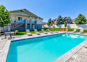 Thumbnail 10 of 24 - A swimming pool in a residential area with houses in the background.