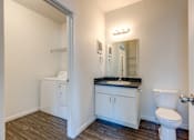 Thumbnail 6 of 24 - A small white bathroom with a toilet, sink, and medicine cabinet.