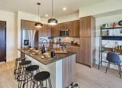 Thumbnail 1 of 48 - a kitchen with wooden cabinets and a large island with a breakfast bar