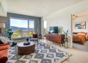 Thumbnail 5 of 48 - a living room with a tv and a bedroom in the background