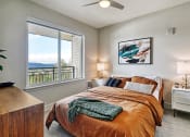 Thumbnail 6 of 48 - a bedroom with a large window and a large bed