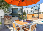 Thumbnail 9 of 10 - TrailView Apartment Homes in Concord, California Patio with BBQ and Seating
