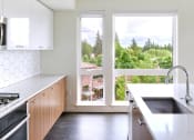 Thumbnail 5 of 26 - Multnomah Station Apartments kitchen with a view