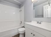 Thumbnail 7 of 8 - North River Apartments bathroom with white cabinets