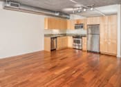 Thumbnail 12 of 29 - A kitchen with wooden cabinets and a stainless steel refrigerator.