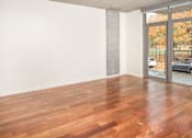 Thumbnail 5 of 29 - A room with wooden flooring and a sliding glass door.