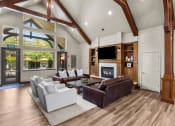Thumbnail 20 of 43 - a spacious living room with a vaulted ceiling and a large window with a view of the