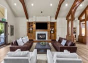 Thumbnail 19 of 43 - a living room with couches and a coffee table in front of a fireplace