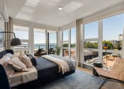 Thumbnail 9 of 26 - Vela Apartments Bedroom with View of Water