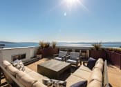 Thumbnail 26 of 26 - Vela Apartments  terrace with a couch and chairs overlooking  water