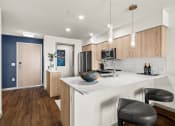 Thumbnail 4 of 26 - Vela Apartments Kitchen with light cabinets and white coutners