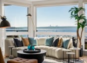 Thumbnail 7 of 26 - Vela Apartments Living Room View of Water