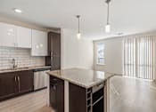 Thumbnail 8 of 23 - A kitchen with a large island and modern appliances.