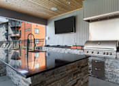 Thumbnail 45 of 48 - a kitchen with a stove top oven and a flat screen tv