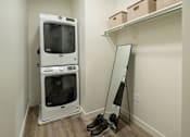 Thumbnail 15 of 30 - a washer and dryer in a room next to a mirror