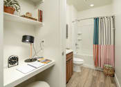 Thumbnail 10 of 30 - Villa Cielo Cortaro Apartments in Tucson, Arizona Built-In Desk and View into Bathroom